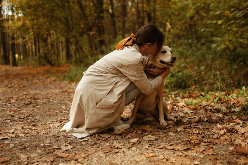 woman hugging her dog outside